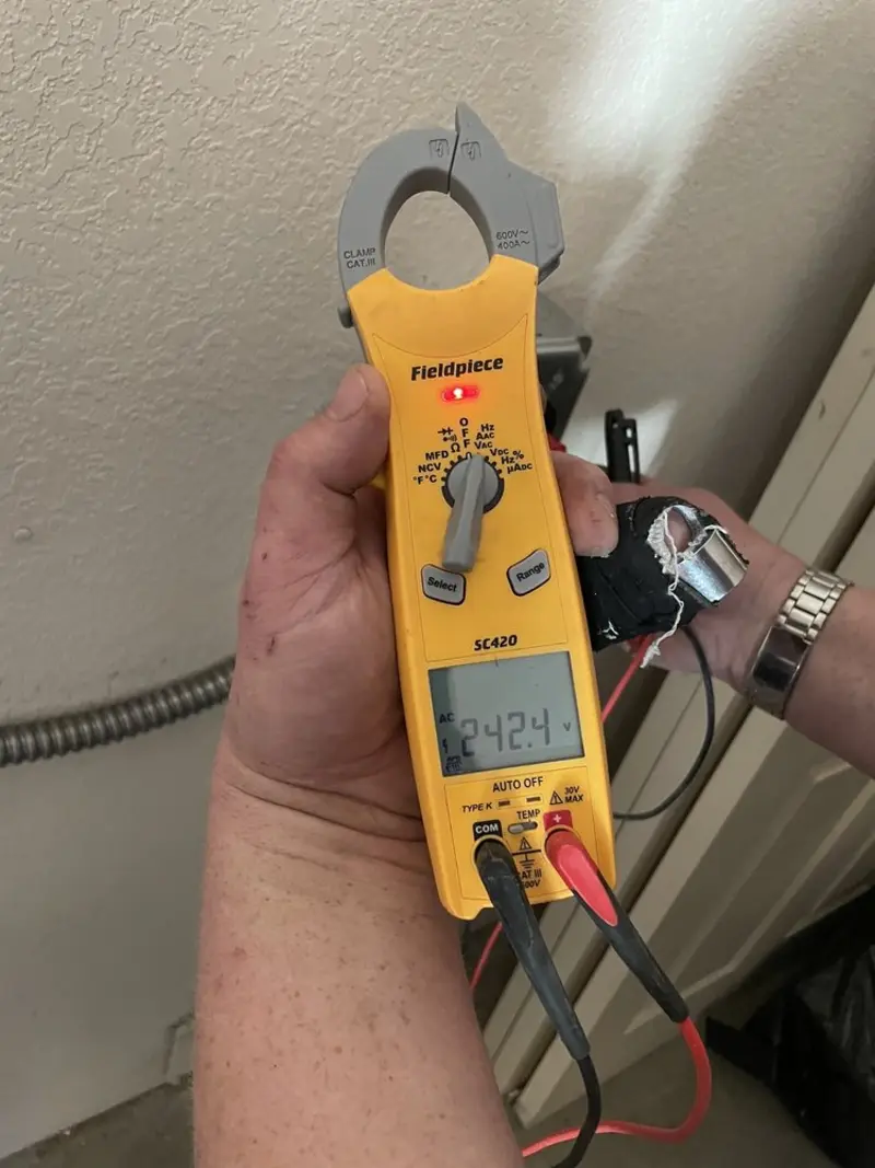 Voltage testing with clamp meter during Electrical Installation Services in Dexter